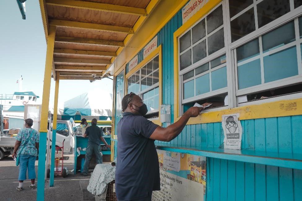 A delivery person from the Supplies Management Agency registers the pharmaceuticals with the Mail Boat’s Office. The Mail Boat (inter-island ferry) transports medical supplies to other islands in The Bahamas. PAHO/WHO Paulterra Johnson