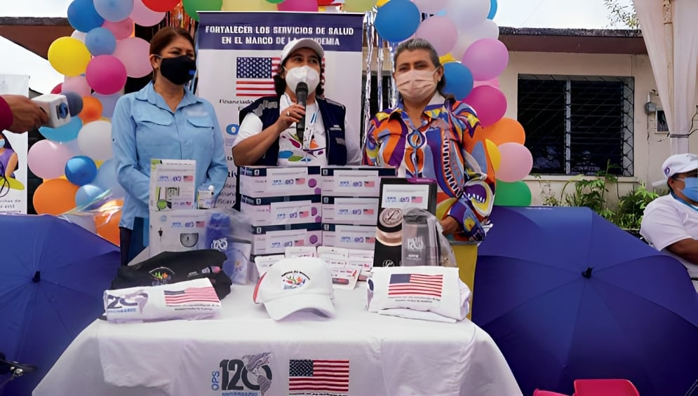 Healthcare event with a table displaying medical supplies and colorful balloons.