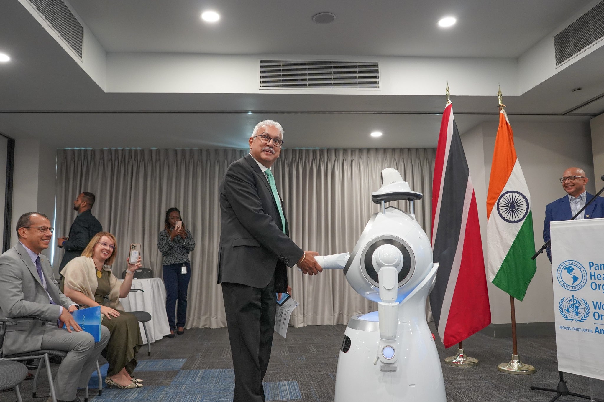 "A Health Service Robot greets the Honourable Terrence Deyalsingh, Minister of Health