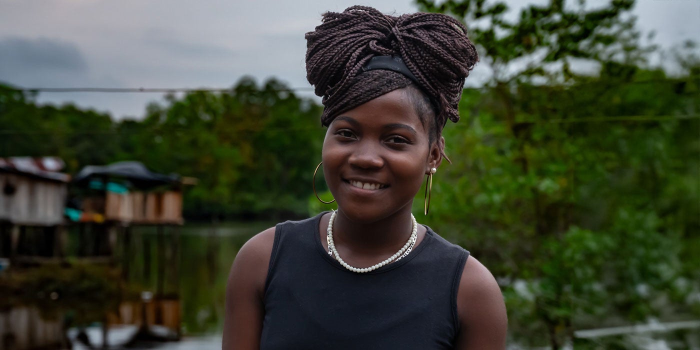 Young afro descendant woman smiling at the camera