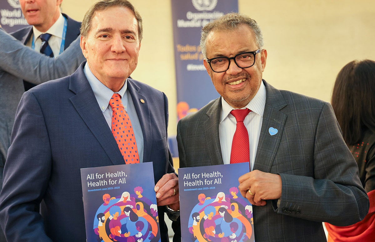 Dr. Jarbas Barbosa and Dr. Tedros holding report "Health for All, All for Health".