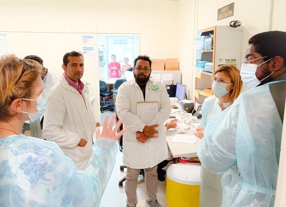 (L-R) Dr. Cornelia Adlhoch - International PAHO Consultant in discussion with Staff of the ERHA Laboratory, Dr. Lidia Redondo Bravo - International PAHO Consultant and Dr Avery Hinds Technical Director of the Epidemiology Division, Ministry of Health during the site visit to the laboratory at the Sangre Grande Hospital