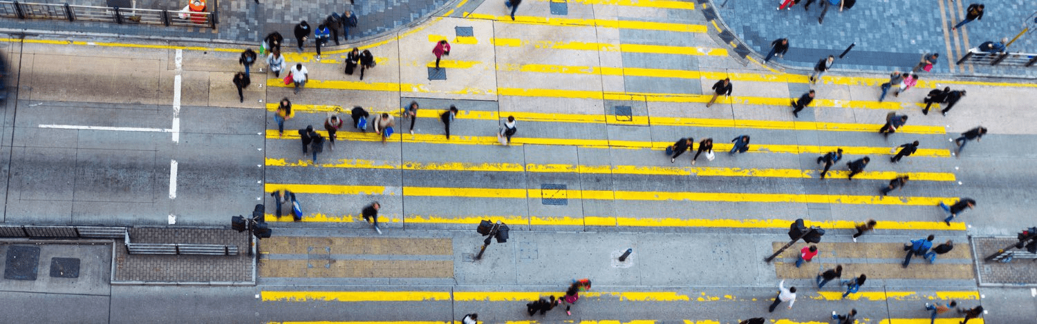 A crowd of people at a busy intersection. 