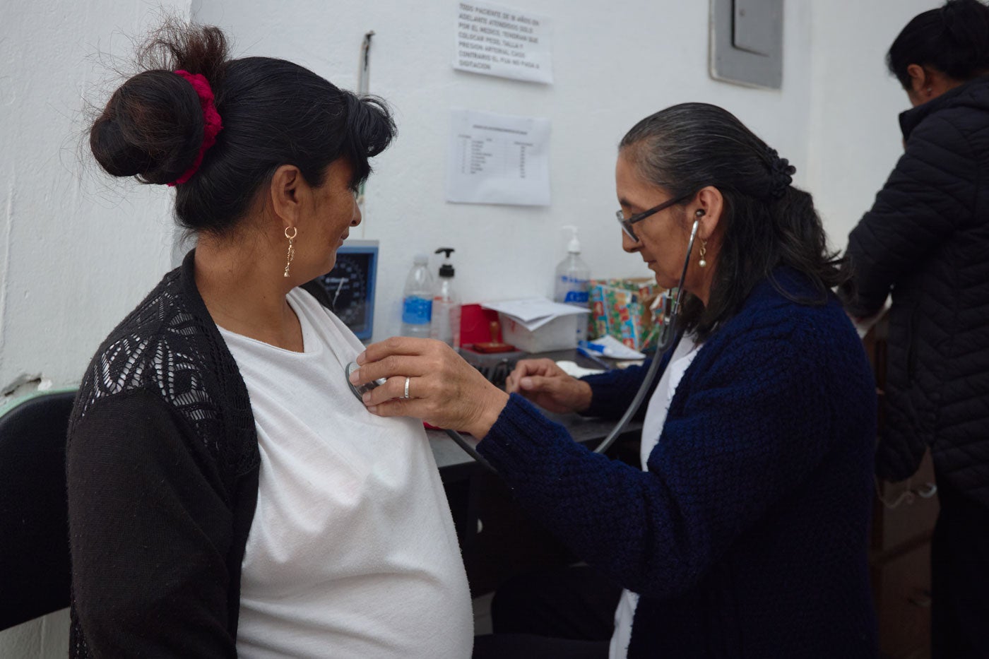 Health worker administers vaccine to pregnant woman