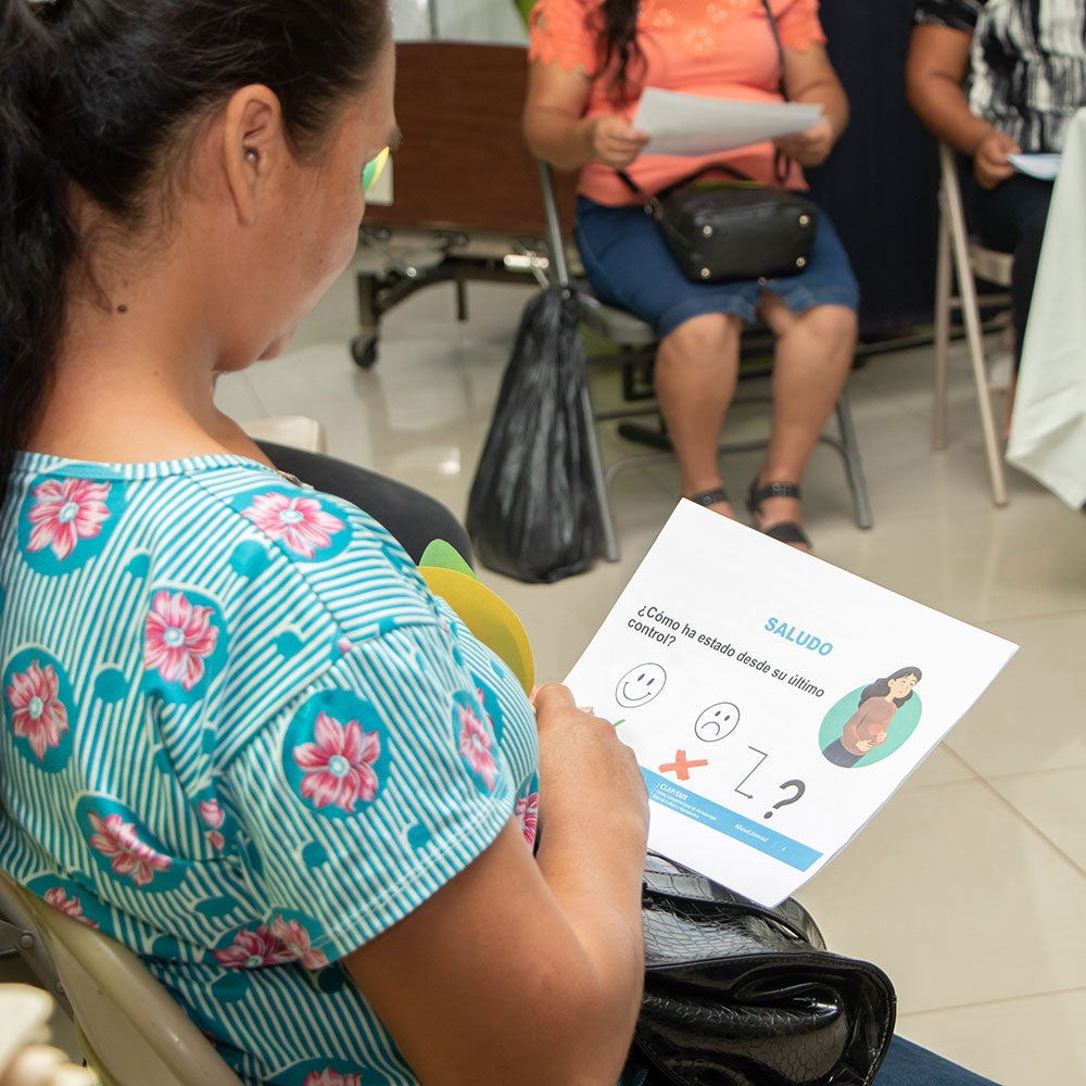 Woman waits seated in health center