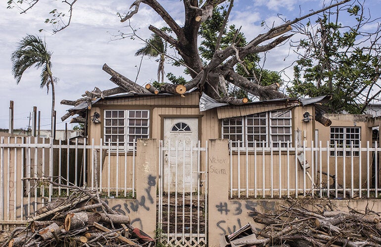 Debris outside house after storm in Puerto Rico