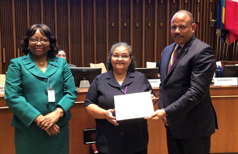Dr. Natalia Largaespada Beer of Belize receiving her award