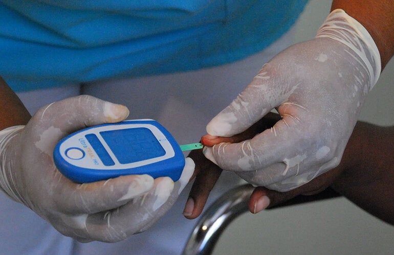 close focuse on health worker testing blood sugar