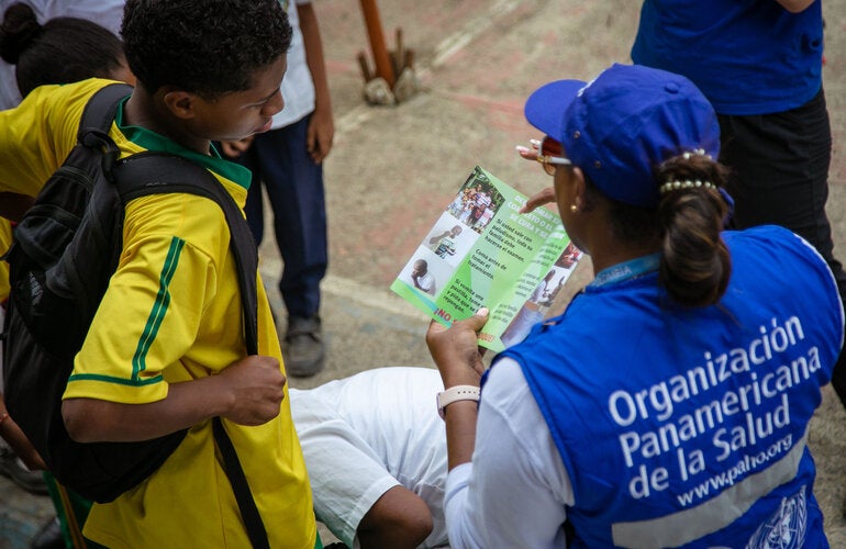 A PAHO female staff has been deployed to rural area. She is sharing health information with an adolescent.