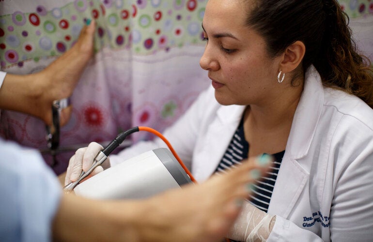 Patient is having an exam by a doctor for HPV