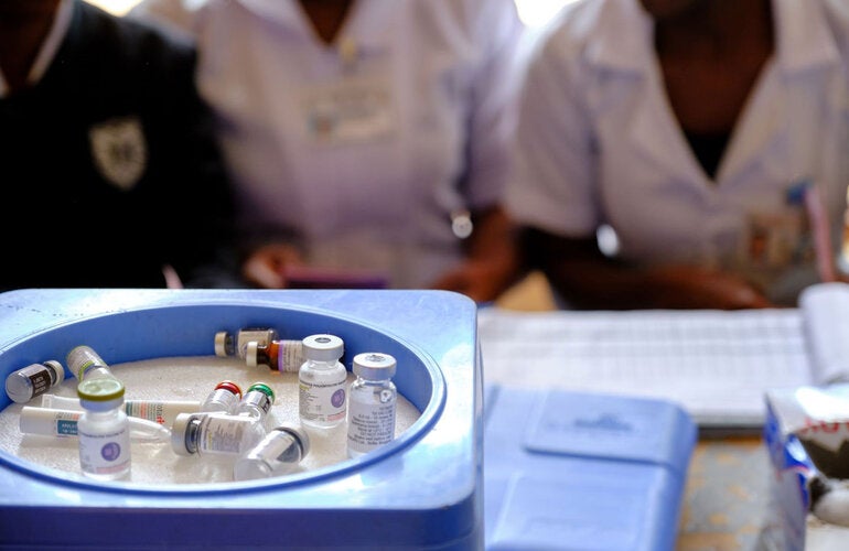 Health workers wait beside vaccine vials - including the malaria, poliomyelitis, tetanus and diphtheria and rotavirus vaccines at Kawale health center in rural Lilongwe, Malawi.