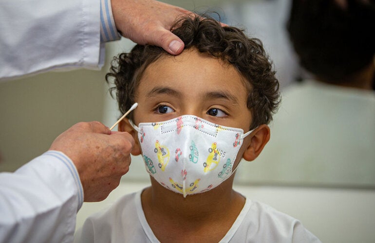 Doctor measures the head circumference of a child.