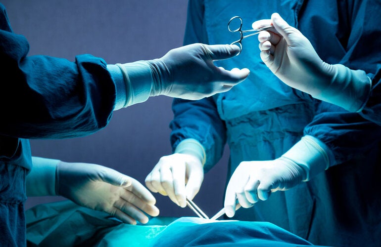 Operating room. Physicians and nurese holding surgical instruments