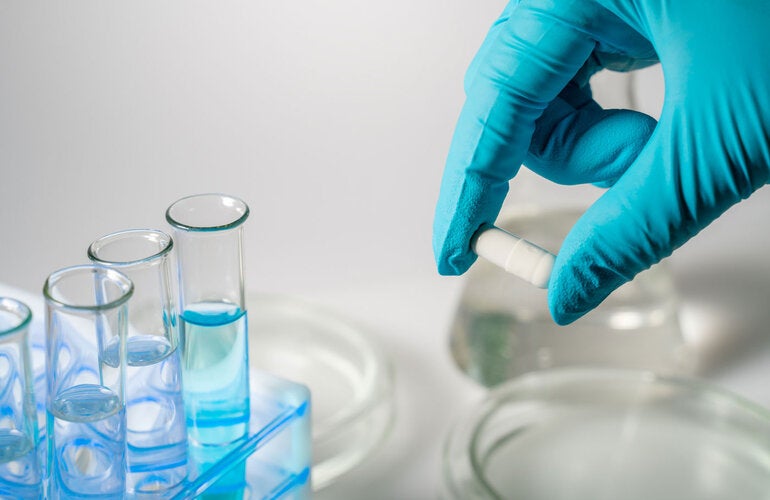 Hand with glove doing research in a medical lab