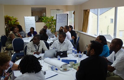 Caribbean participants work in groups.