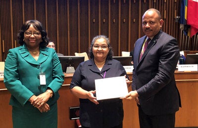Dr. Natalia Largaespada Beer of Belize receiving her award