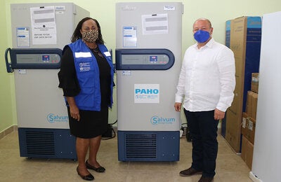 Photo of PWR and Minister of Health flanking the ULT Freezer