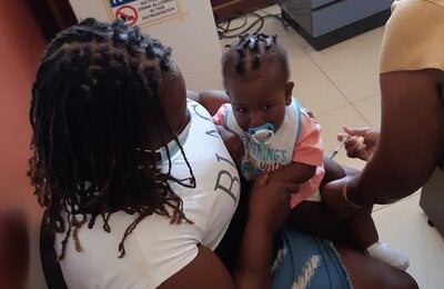 Baby gets immunized at the Kitson Town Health Centre