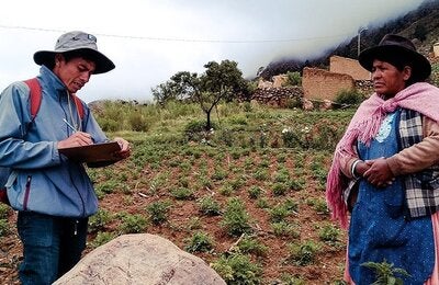 A pollster ask a questionaire to a woman in a rural area in an Andean country