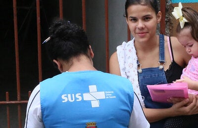 woman in a door holding a child