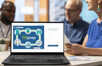 2 men and a woman in an office. A laptop screen showing the app O2prep login form