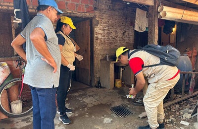 Personnel doing a house inspection to remove possible breeding grounds for mosquiotes