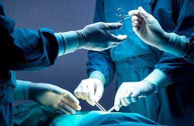 Operating room. Physicians and nurese holding surgical instruments