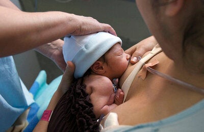 woman breastfeeding a premature baby