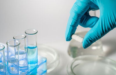 Hand with glove doing research in a medical lab