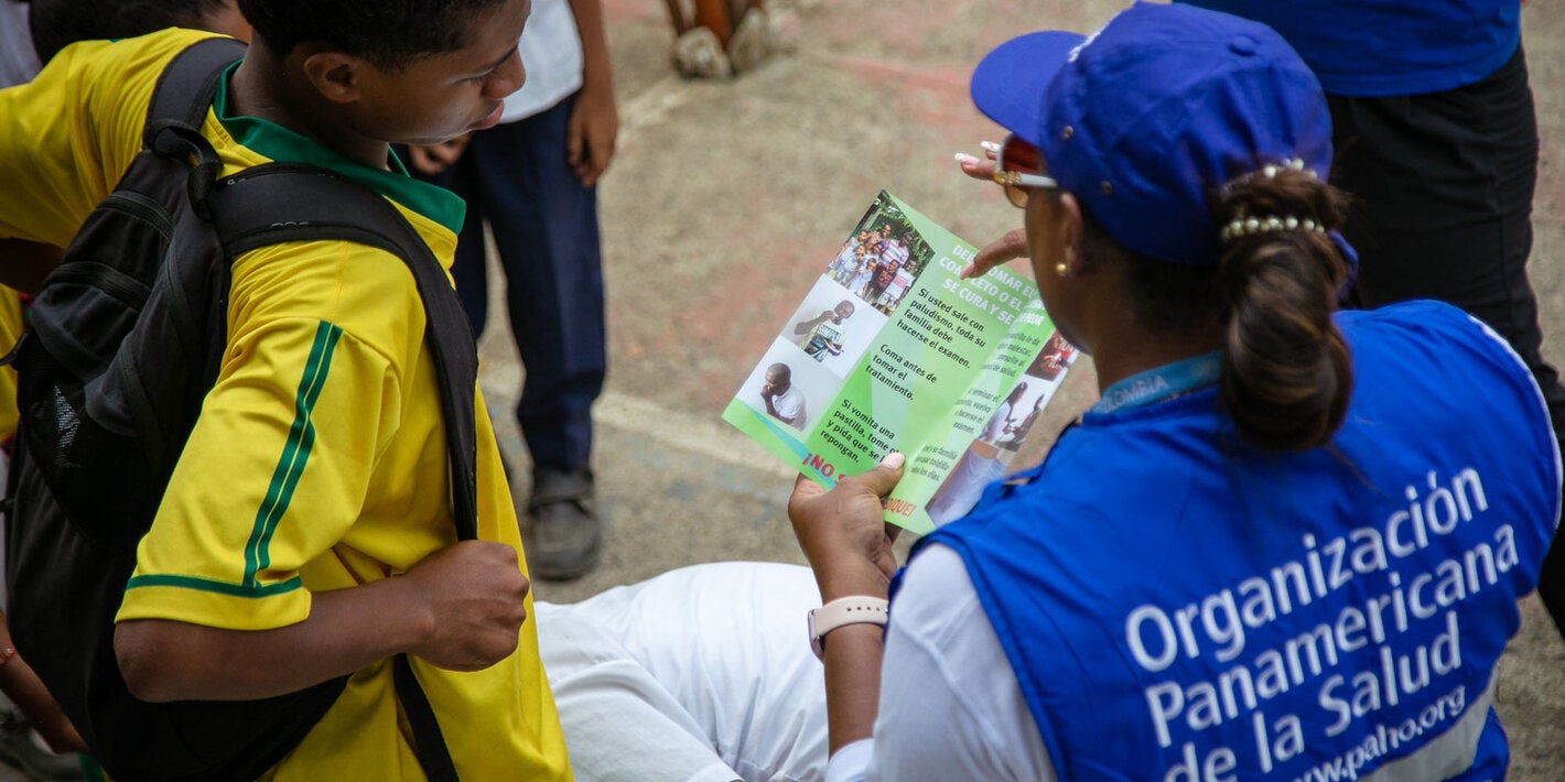 A PAHO female staff has been deployed to rural area. She is sharing health information with an adolescent.