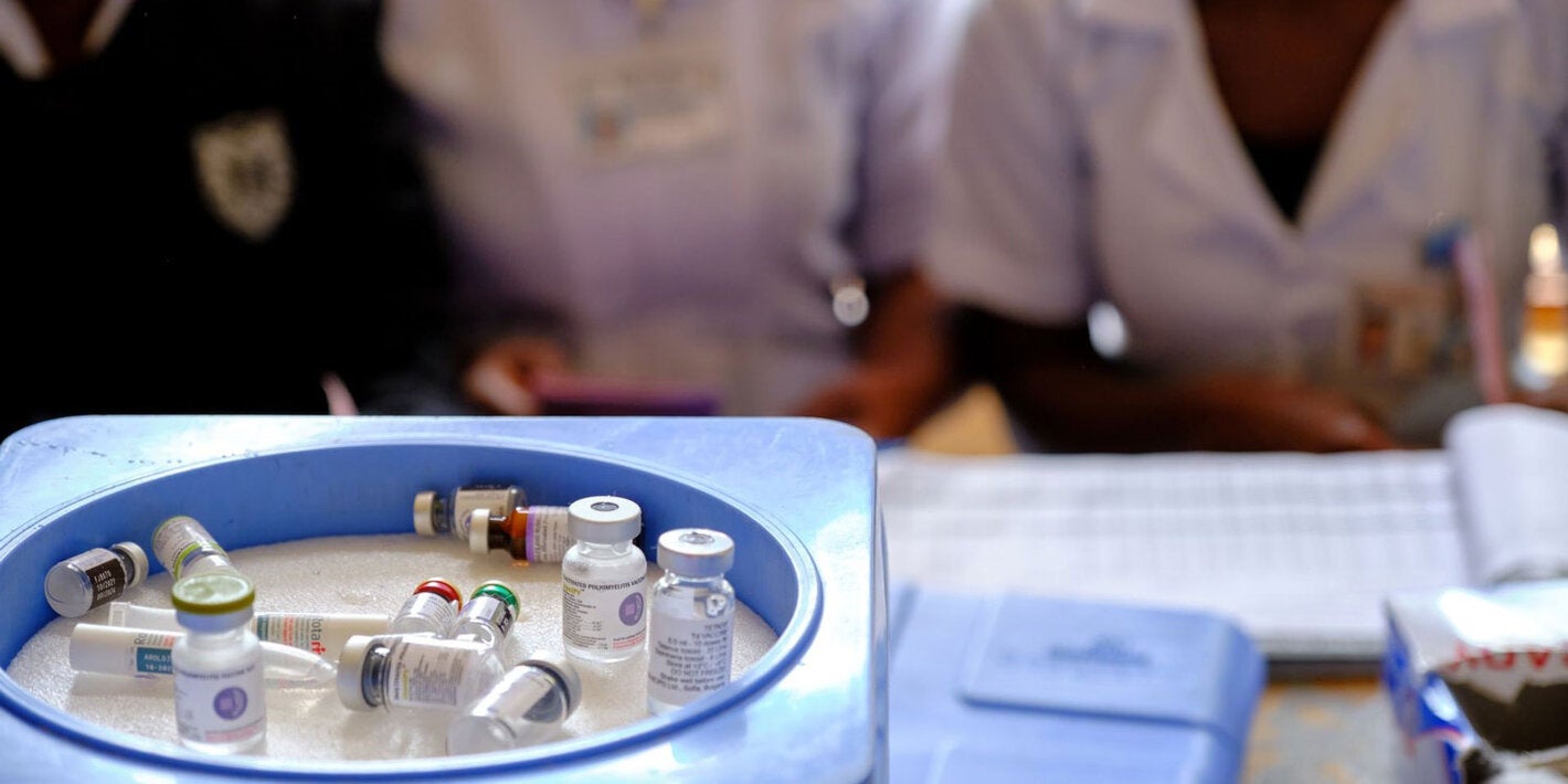 Health workers wait beside vaccine vials - including the malaria, poliomyelitis, tetanus and diphtheria and rotavirus vaccines at Kawale health center in rural Lilongwe, Malawi.