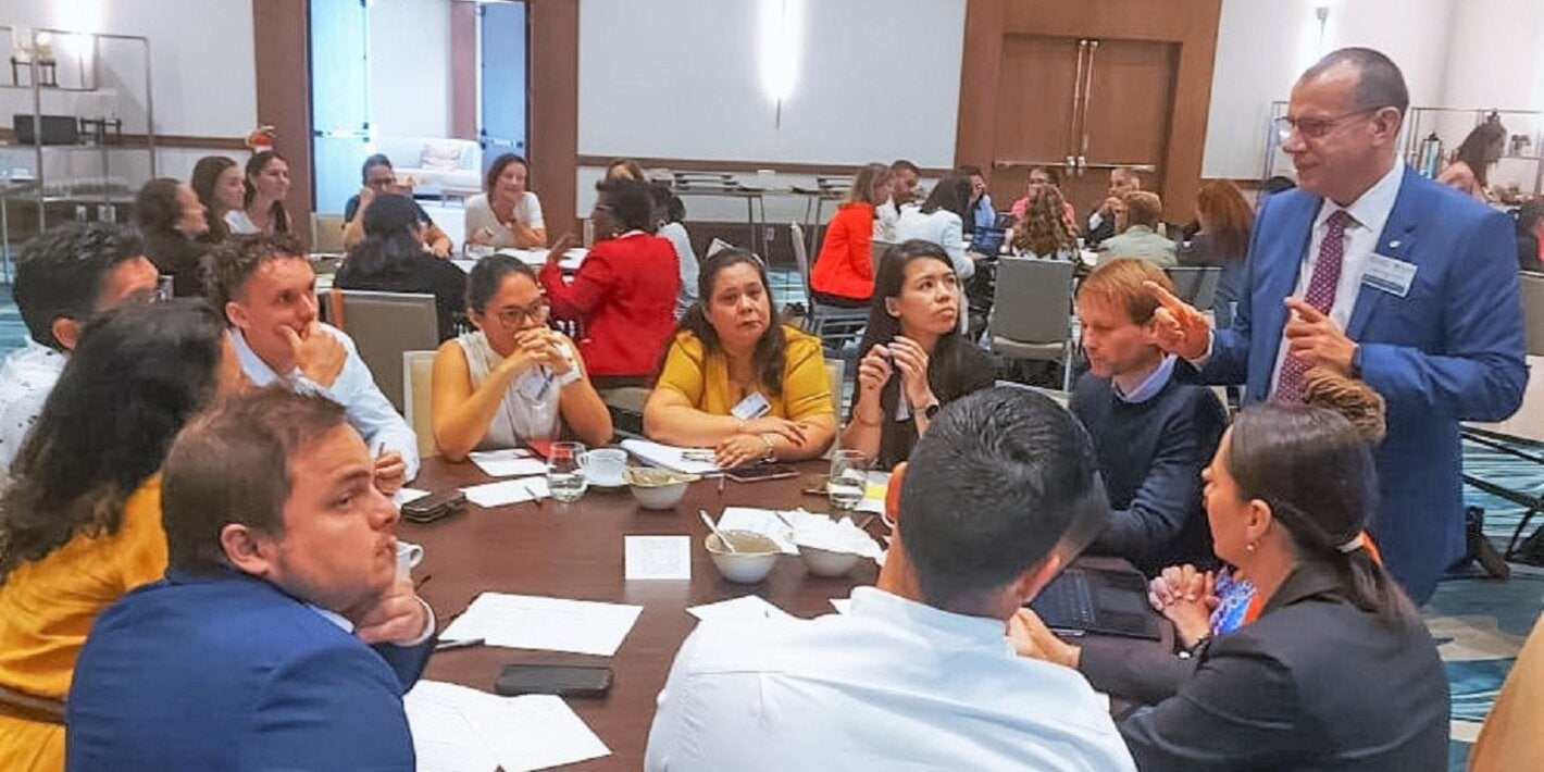 Dr Gabriel Vivas Francesconi, PAHO/WHO Representative for Trinidad and Tobago, Aruba, Curacao, Sint Maarten, Bonaire, St Eustatius and Saba (standing), facilitates one of the working group sessions during the consultation