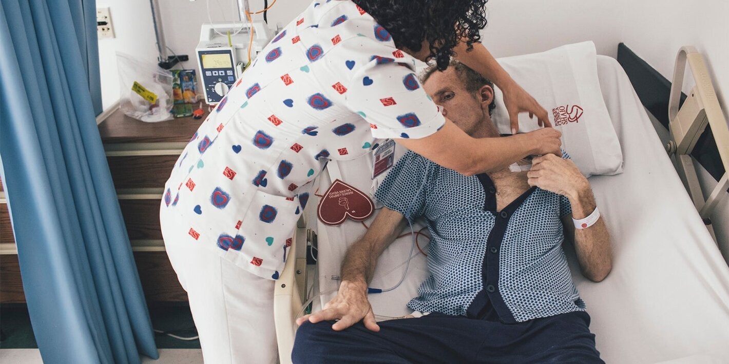 Nurse takes care of patient in hospital setting