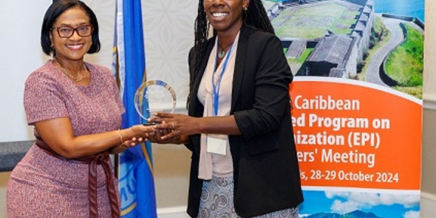 "Jamaica's EPI Manager, Dr Julia Rowe-Porter accepting her award from Chief Medical Officer, Dr Hazel Laws of St Kitts and Nevis"