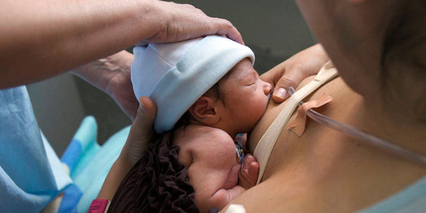 woman breastfeeding a premature baby