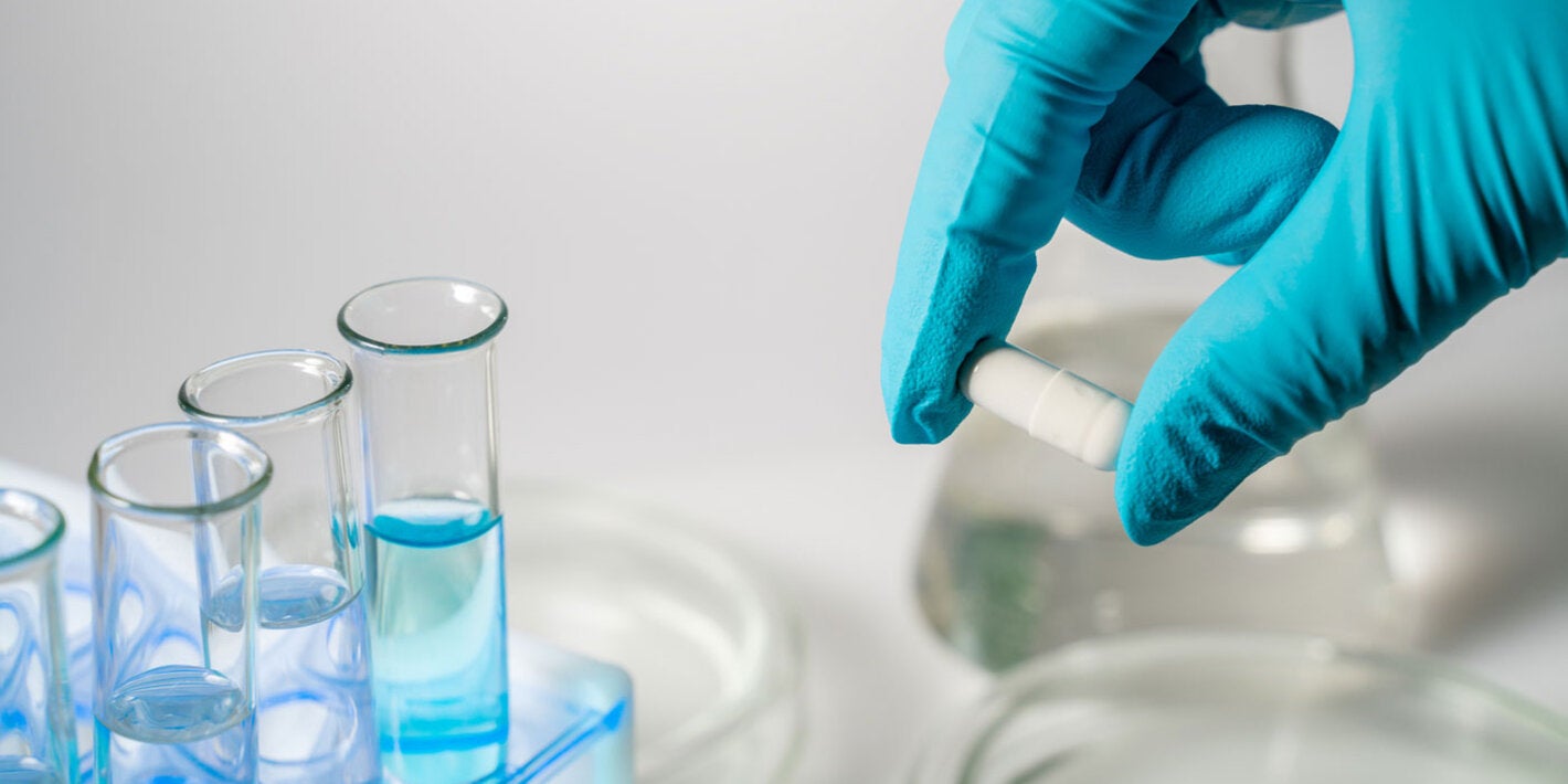 Hand with glove doing research in a medical lab