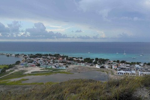 high angle view of city by sea against sky