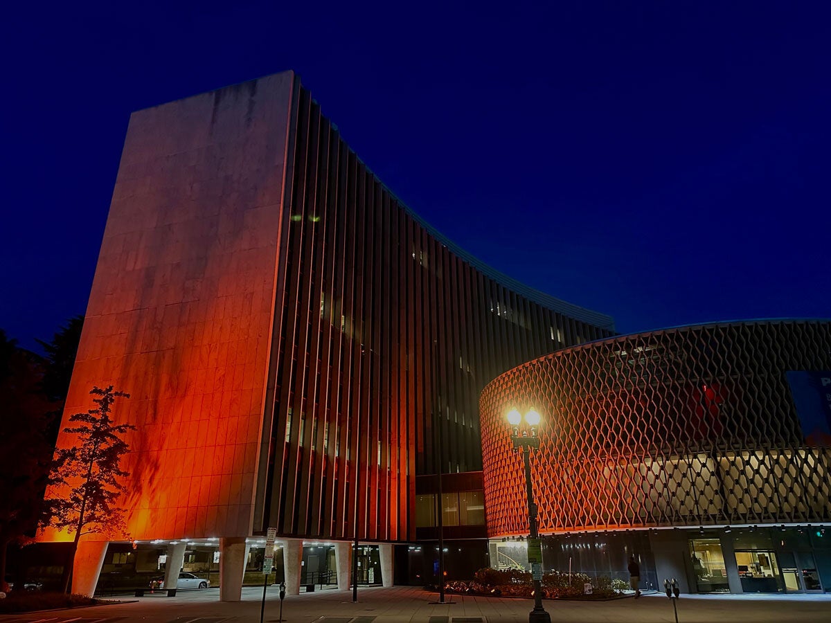 PAHO HQ building illuminated with orange lights