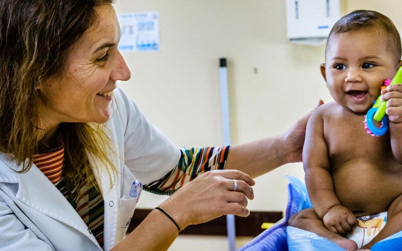 happy baby with doctor after getting vaccinated