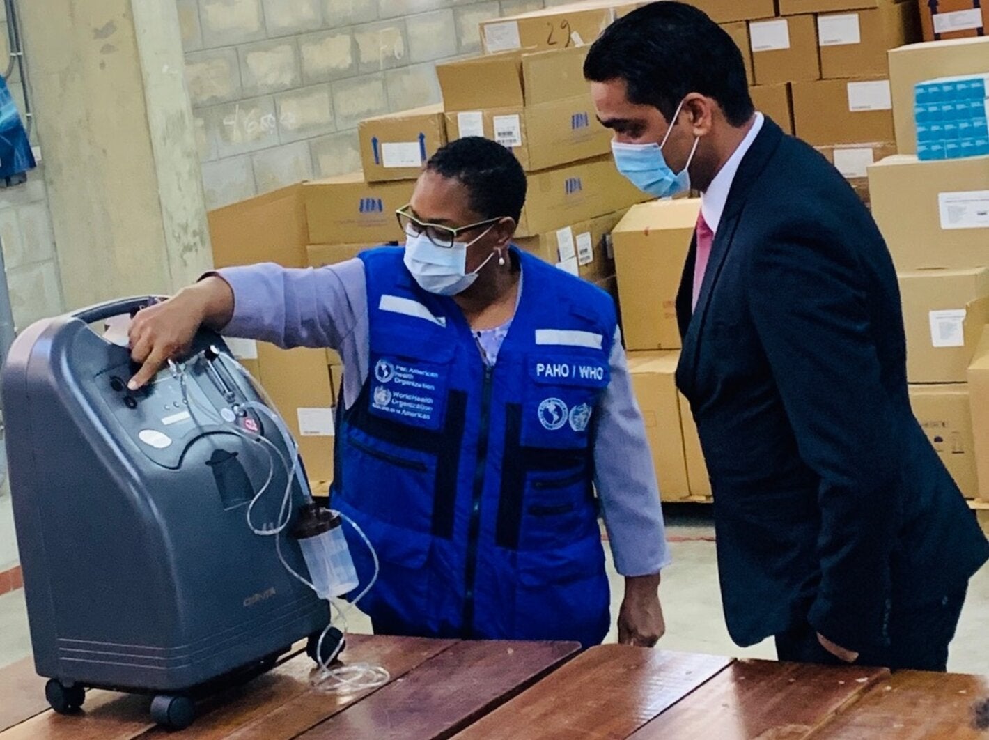 PAHO/WHO Representative for Suriname, Dr. Karen Lewis-Bell officially hands-over 20 oxygen concentrators to Dr. Amar Ramadhin, Minister of Health.