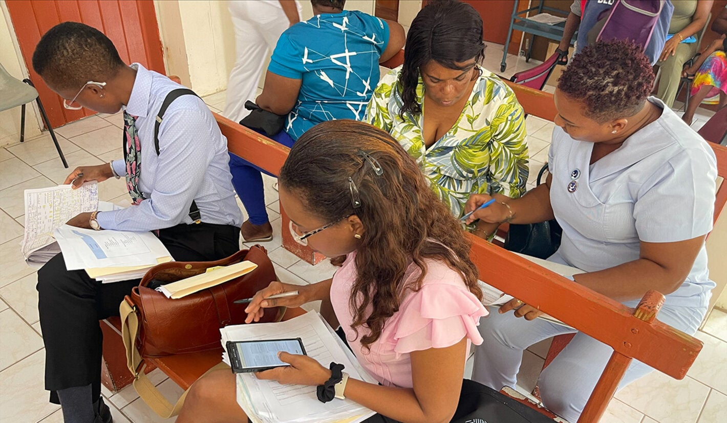 Consultants review documents at a clinic in Dominica