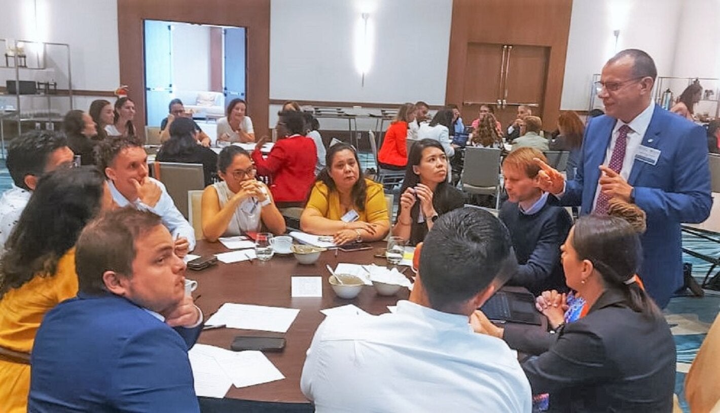 Dr Gabriel Vivas Francesconi, PAHO/WHO Representative for Trinidad and Tobago, Aruba, Curacao, Sint Maarten, Bonaire, St Eustatius and Saba (standing), facilitates one of the working group sessions during the consultation