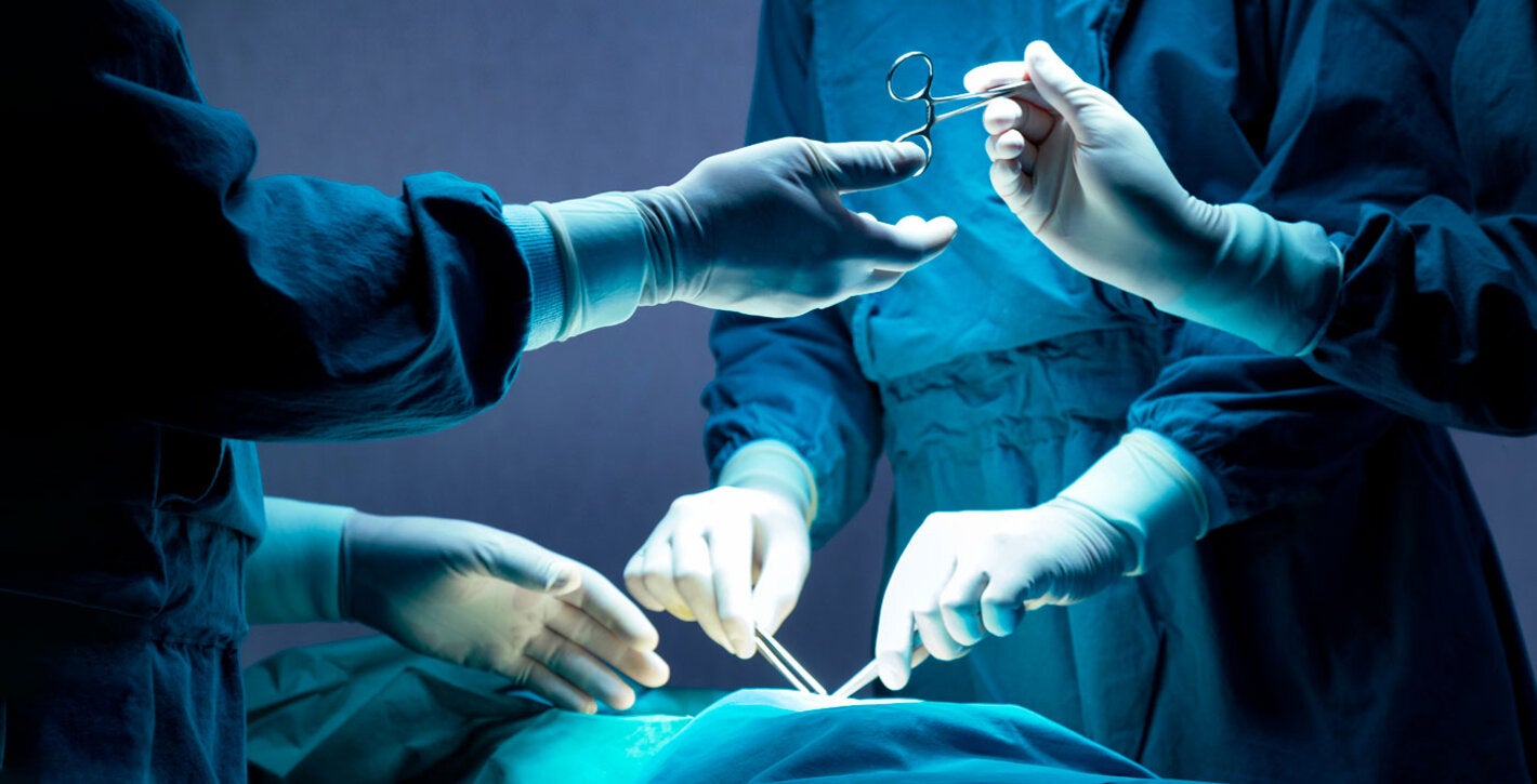 Operating room. Physicians and nurese holding surgical instruments