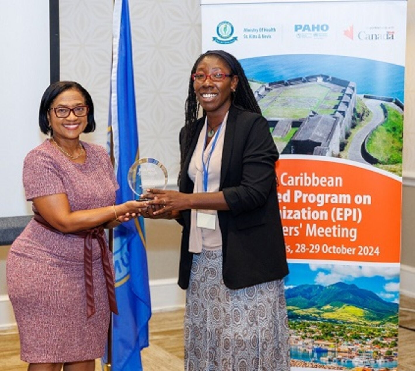 "Jamaica's EPI Manager, Dr Julia Rowe-Porter accepting her award from Chief Medical Officer, Dr Hazel Laws of St Kitts and Nevis"