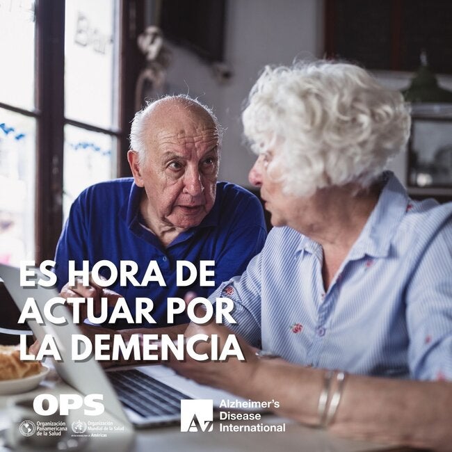 Fotografía de una pareja de edad avanzada conversando en torno a una computadora