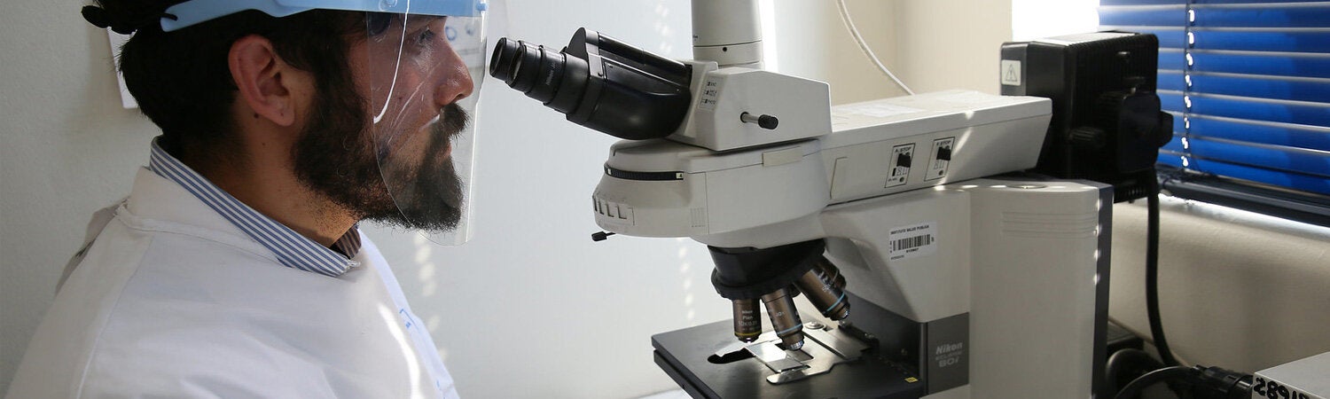 Biochemist analyzing a sample of human T-lymphotropic virus (HTLV) in a laboratory