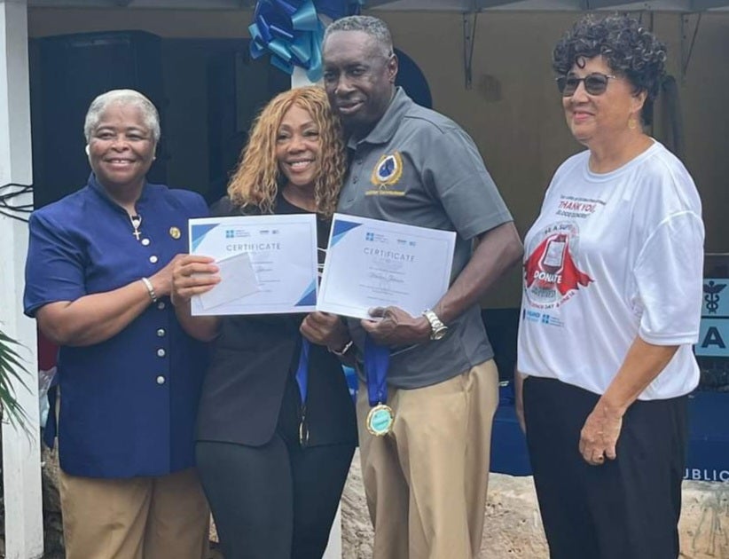 Mr. and Mrs. Warren Johnson being recognized for their blood donations at the World Blood Donor Day Ceremony. Also pictured are Ms. Mary Walker, Hospital Administrator, Princess Margaret Hospital, The Bahamas and Dr. Hedwig Goede, Health Systems Strengthening Advisor, PAHO/WHO Country Office-The Bahamas and Turks and Caicos Islands.